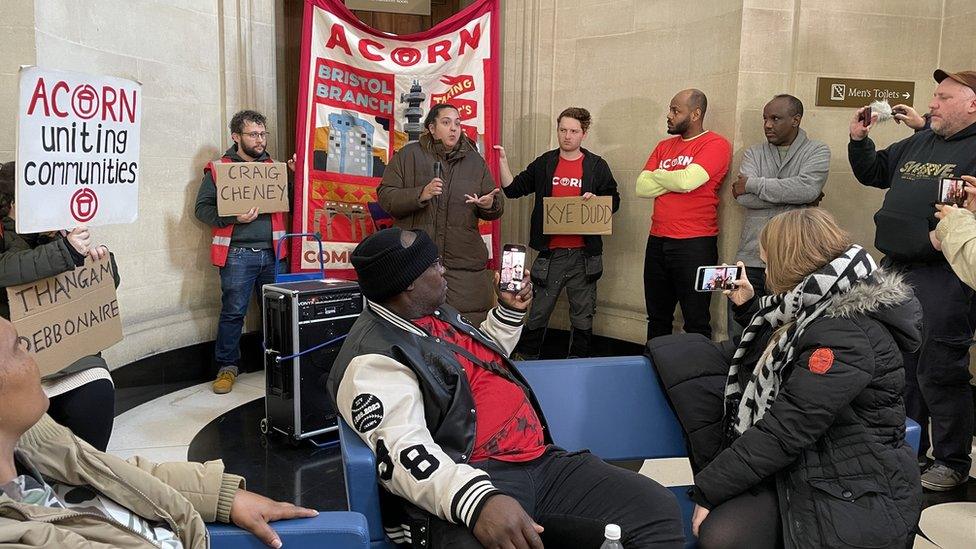 Protesters holding placards demanding action from Bristol City Council