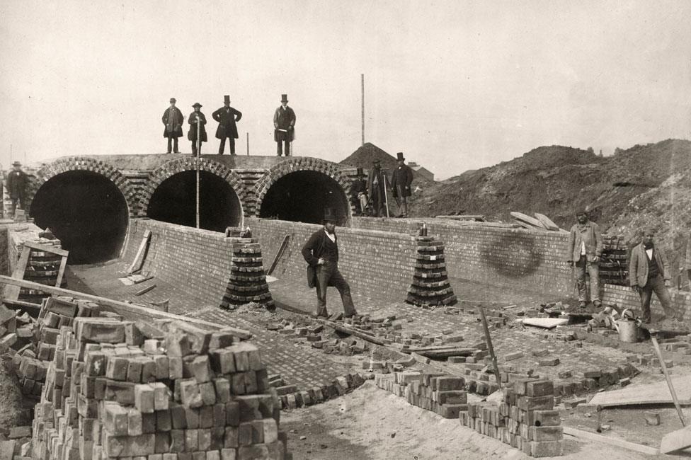 Joseph Bazalgette, standing top right, views the Northern Outfall sewer being built below the Abbey Mills pumping station in 1862