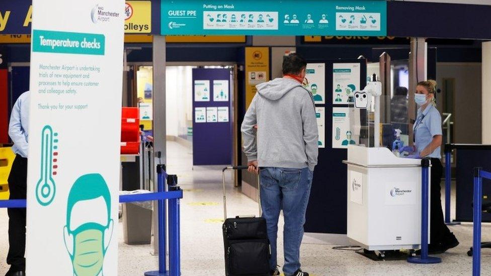 A passenger at a temperature check area at Manchester Airport