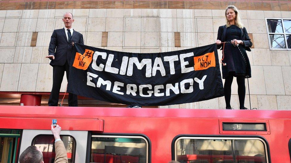 Climate protestors on top of bus