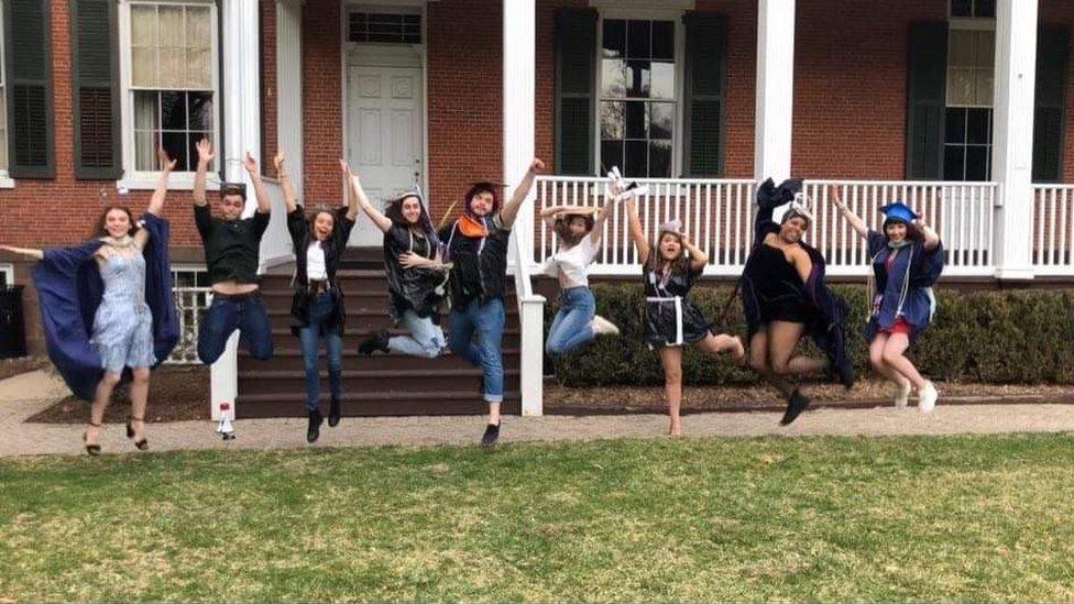 Students jump in unison at their "mock graduation" at Drew University