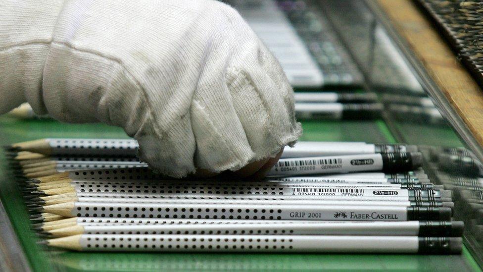 An employee checks finished lead pencils at the Faber-Castell plant in Germany