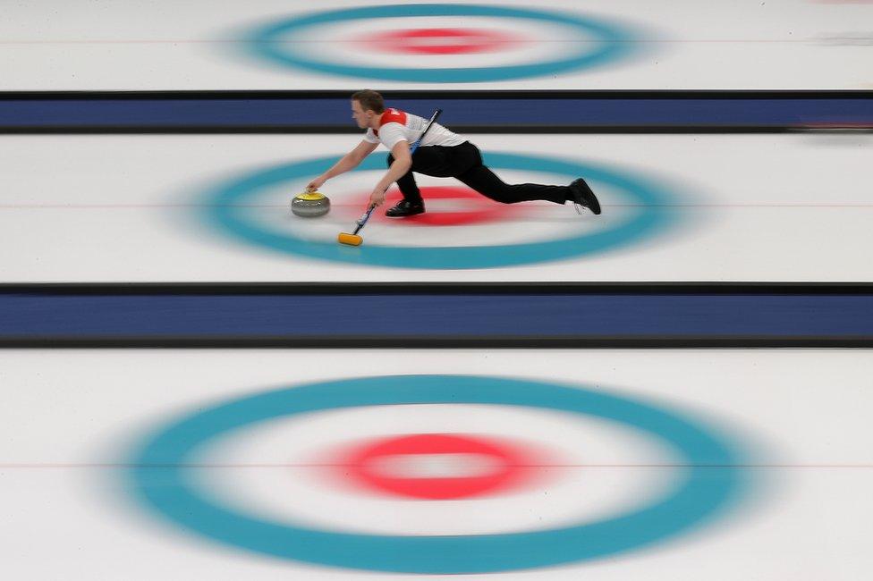 Magnus Nedregotten slides along the ice whilst Curling