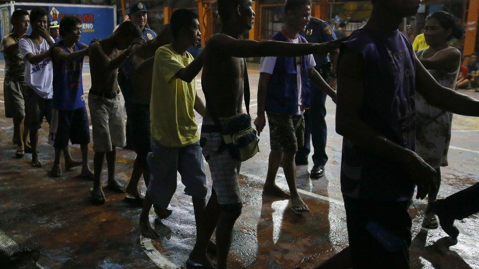 Police round up residents during an operation in "War on Drugs" campaign of President Duterte at slum community of Tondo in Manila, Philippines. 30 September 2016