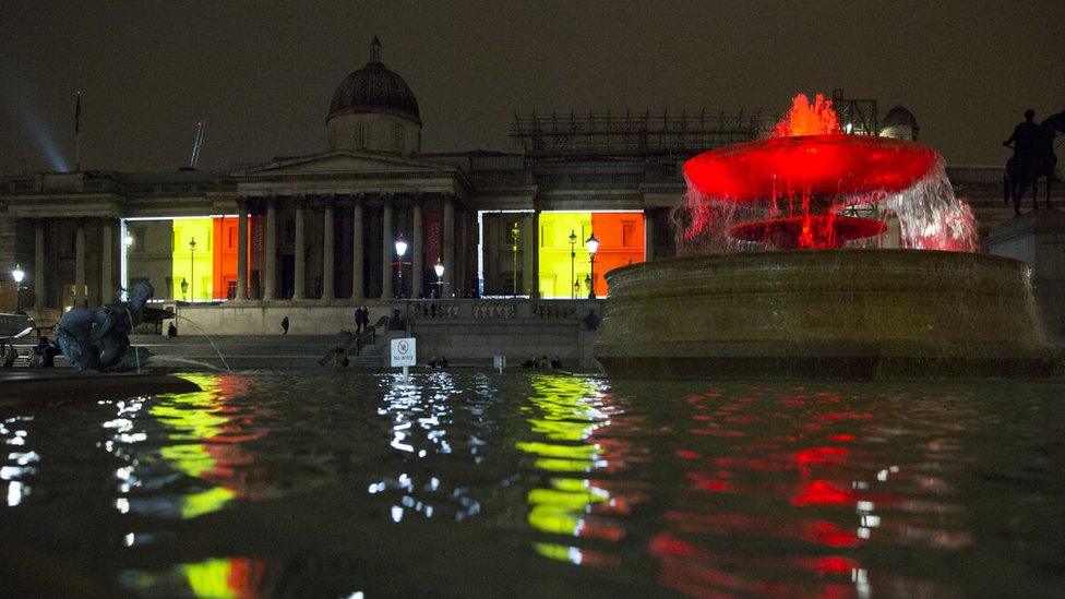 The black, yellow, and red colours of the Belgian flag are projected on the National Gallery