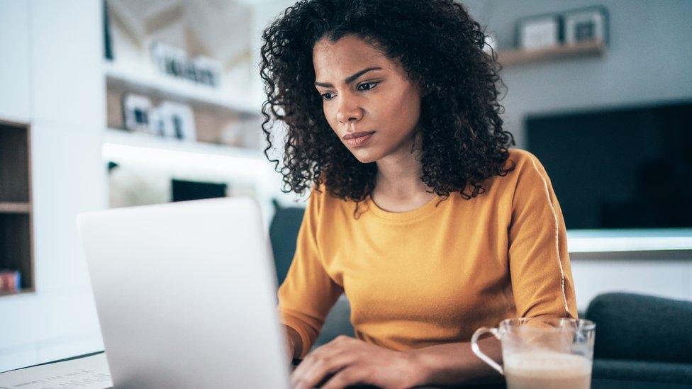 Woman working on computer at home