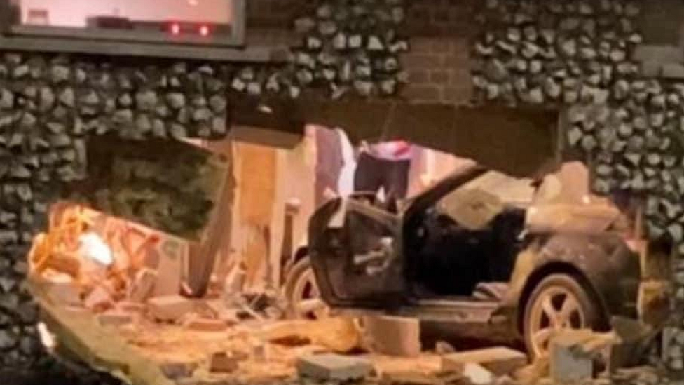 car smashes through wall