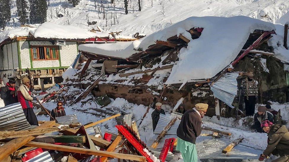 Villagers searching through rubble in the Neelum Valley