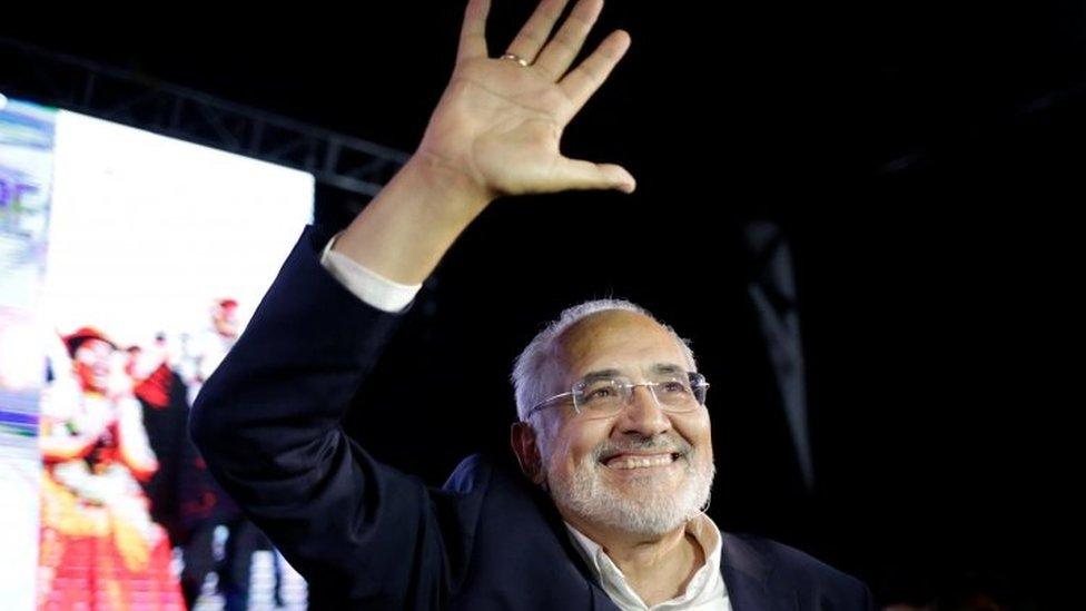 Bolivian presidential candidate Carlos Mesa waves following the results of the first round in La Paz, Bolivia.