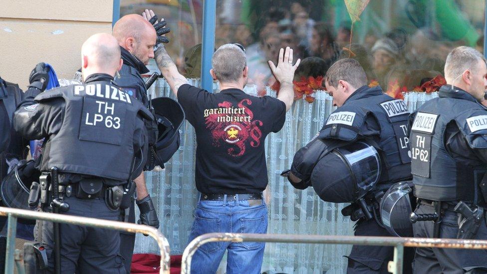 Police searching a neo-Nazi ahead of a concert in the German town of Apolda (6 October)