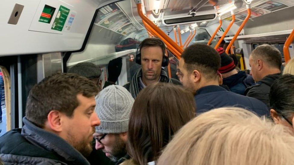 Commuters crowded on a South Western Railway train