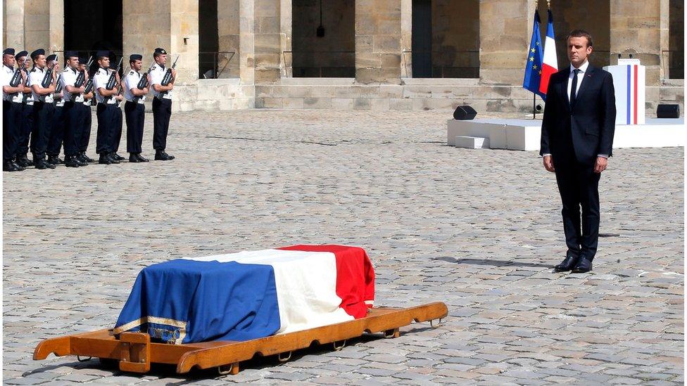 Emmanuel Macron (R) stands in front of the flag-draped coffin of Simone Veil during a solemn funeral ceremony, in the courtyard of the Invalides in Paris, France, 05 July 2017.