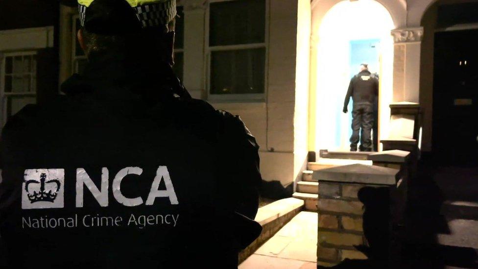 An NCA officer at the scene of Monday morning's raid