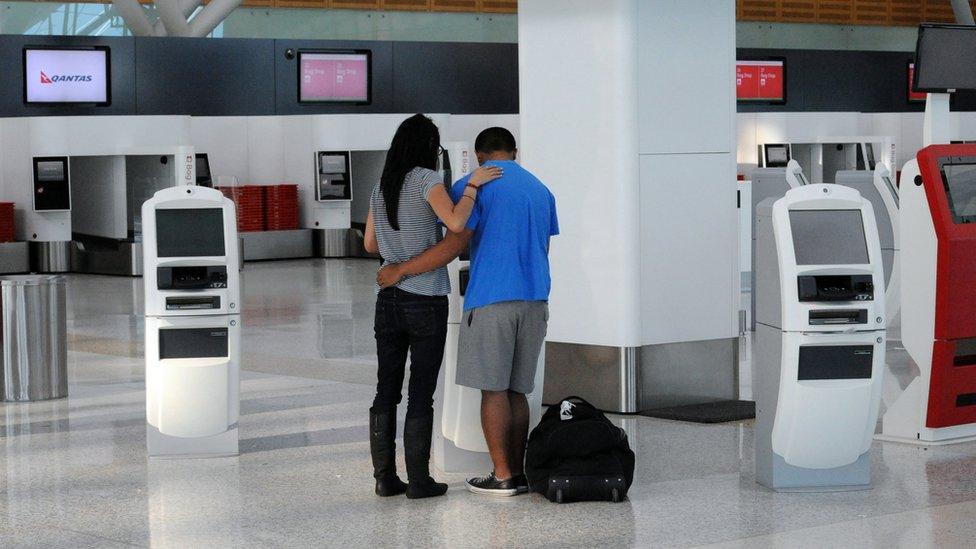 A lone couple at an airport terminal in Sydney