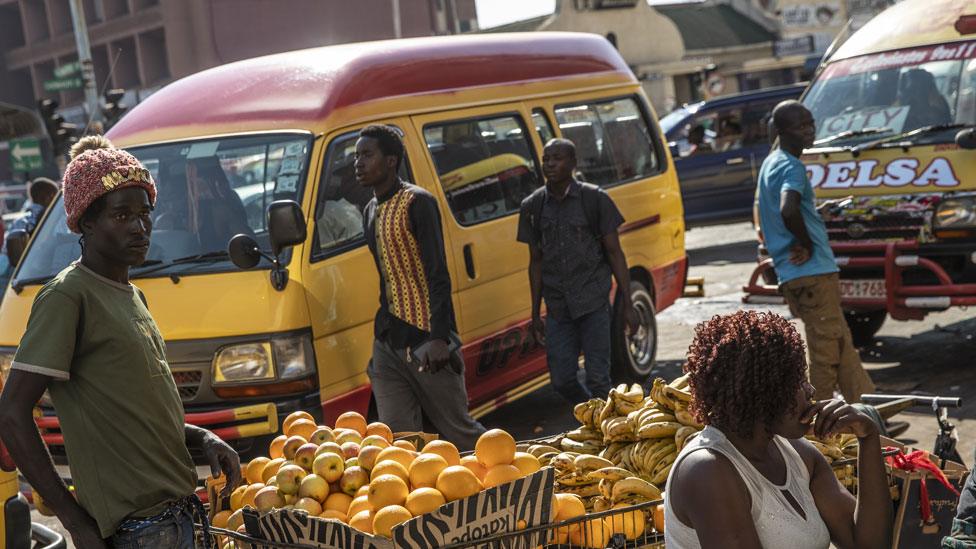 Minibuses and vendors in the centre of Harare, Zimbabwe