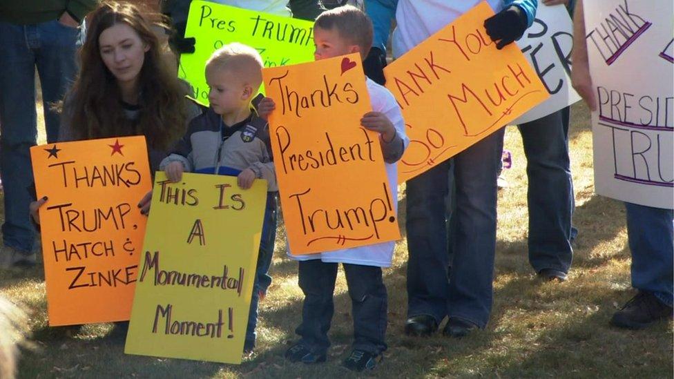 Children are pictured with signs saying 'Thanks President Trump'