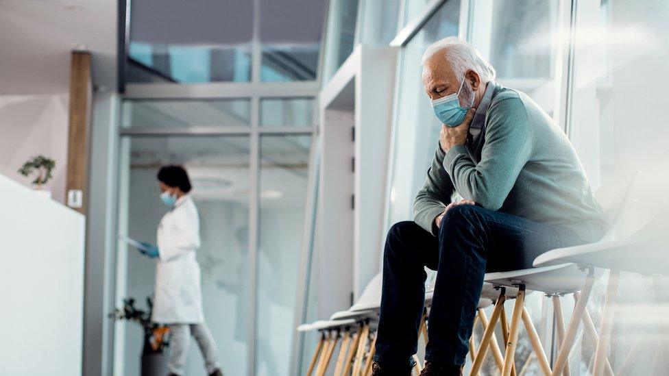 an older man waiting in hospital