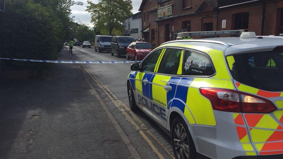 Police car in cordoned off street