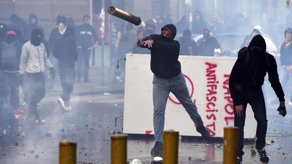 Protesters throw objects during clashes with riot police at a demonstration against the visit of the leader of the Northern League party Matteo Salvini, in Naples, Italy, 11 March 2017