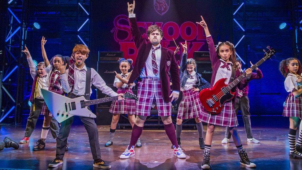 David Fynn (Dewey Finn) and the young cast of School of Rock