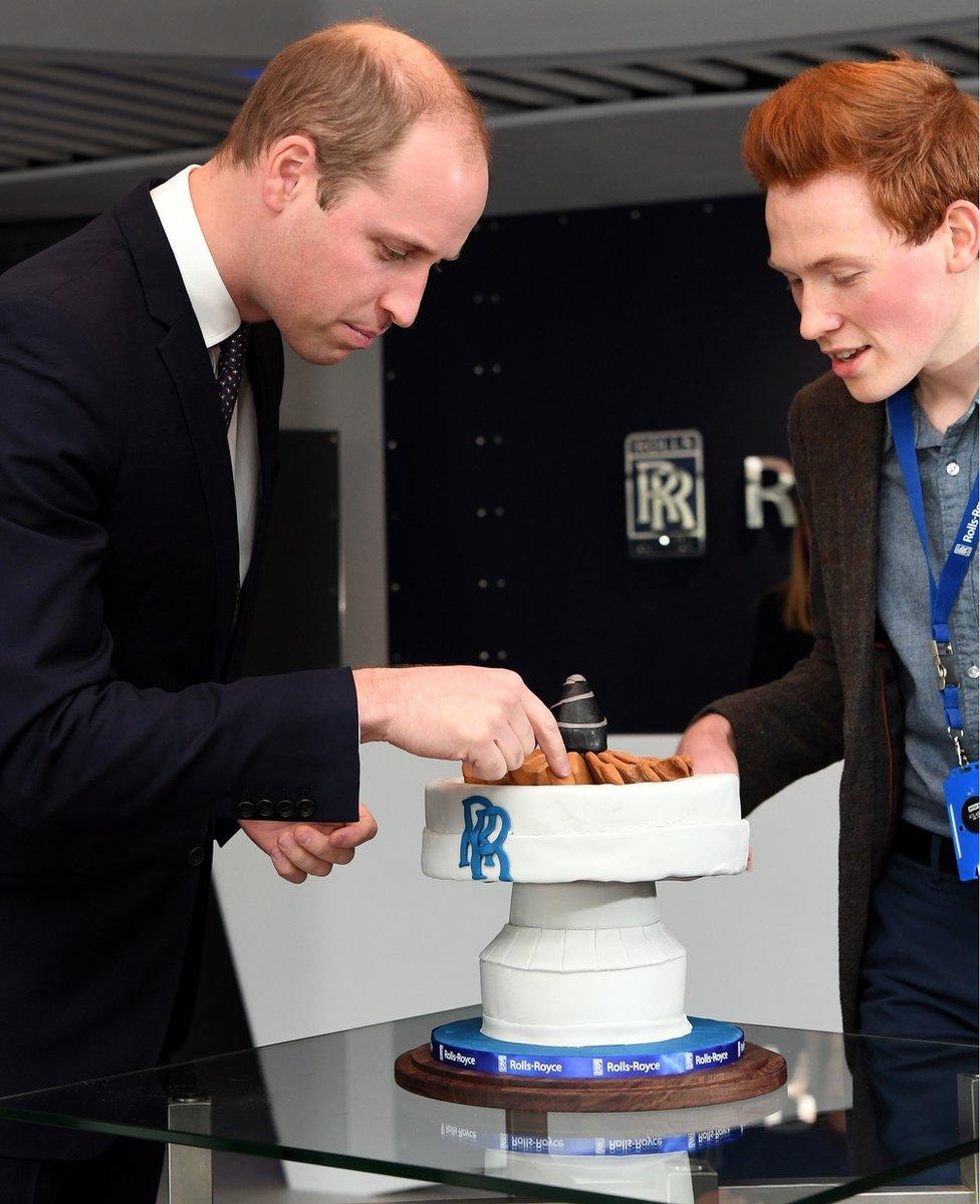 Prince William, Duke of Cambridge is presented with a cake by aerospace engineer and Bake Off runner-up Andrew Smyth during a visit to the Rolls-Royce technology centre on November 30, 2016 in Derby