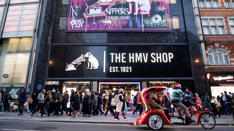 People walk past the reopened HMV flagship store