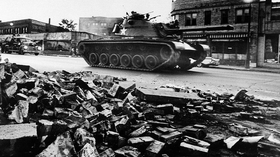 A tank patrols a Detroit street on 25 July 1967