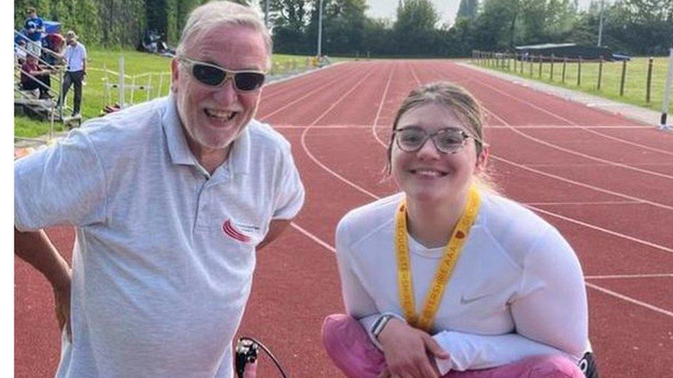 Coach Bob and frame runner Charlie smiling for a photo