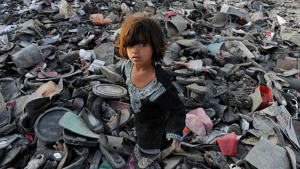 An Afghan girl scavenges for recyclable items on the outskirts of Kabul on October 4, 2011.