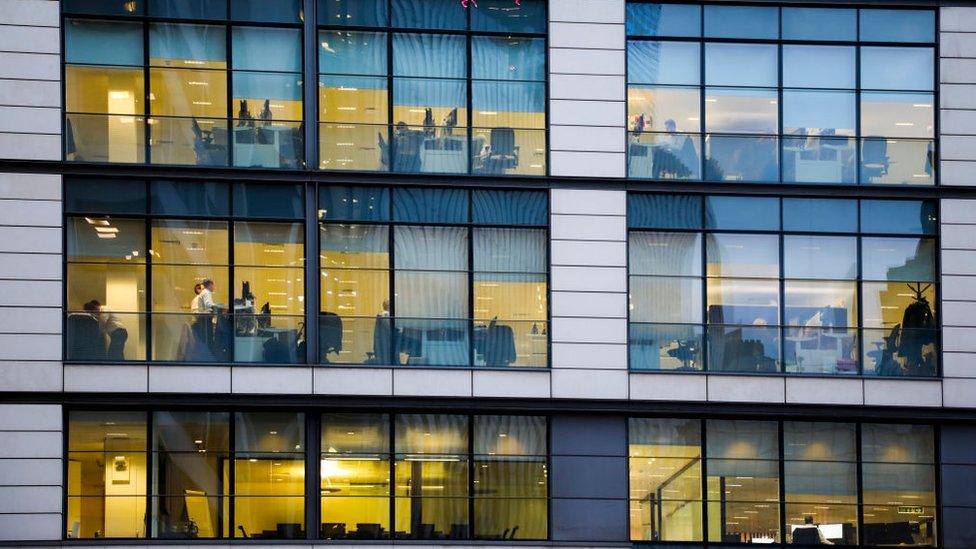 Office block with workers visible through the windows