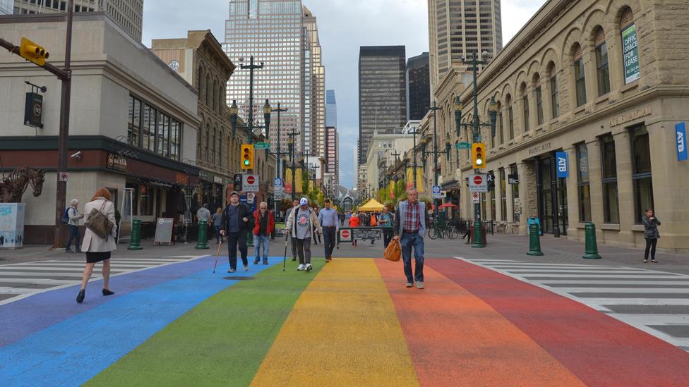 Albertans walk along an 'LGBT road crossing' in Calgary downtown