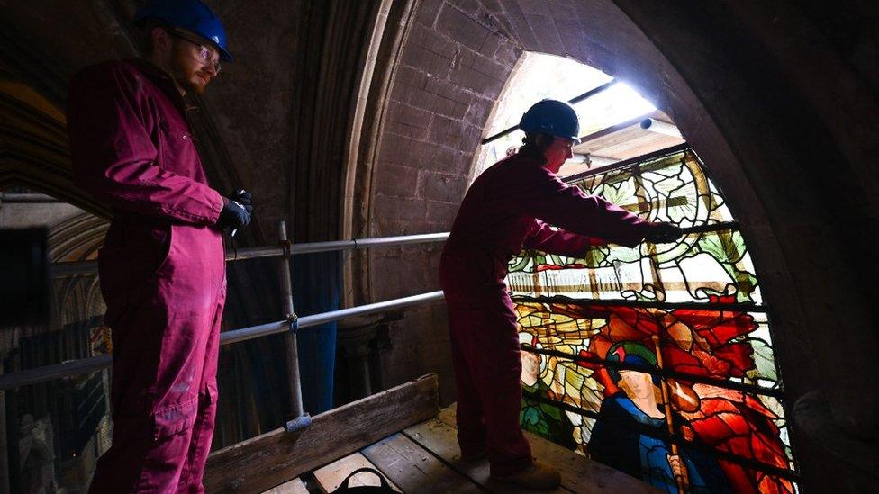 The glazing team removing the fragile sections of stained glass