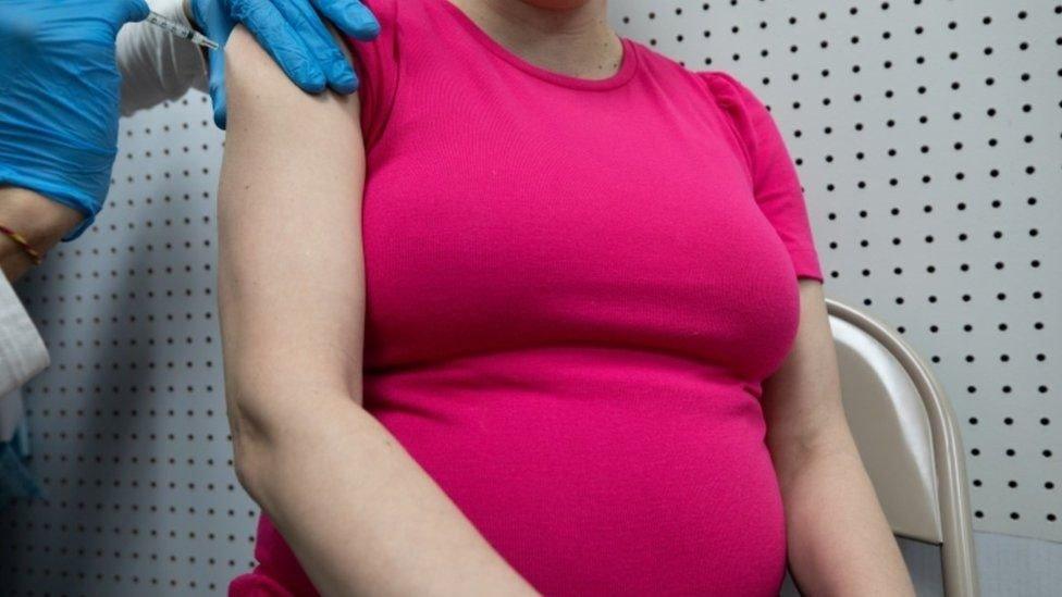 Pregnant woman getting vaccine