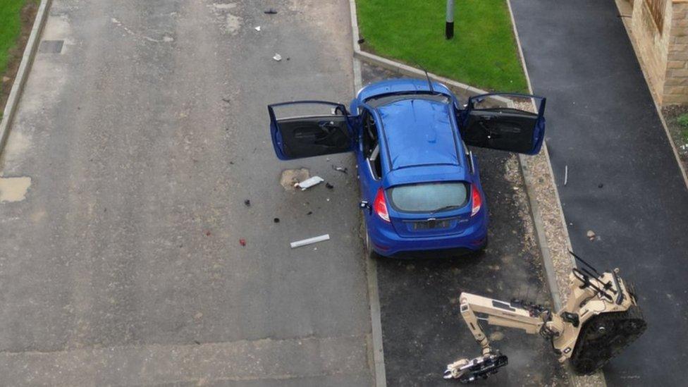 Damaged car on quiet street