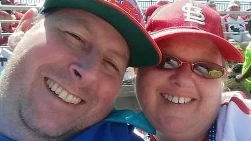 Man and woman at baseball game.