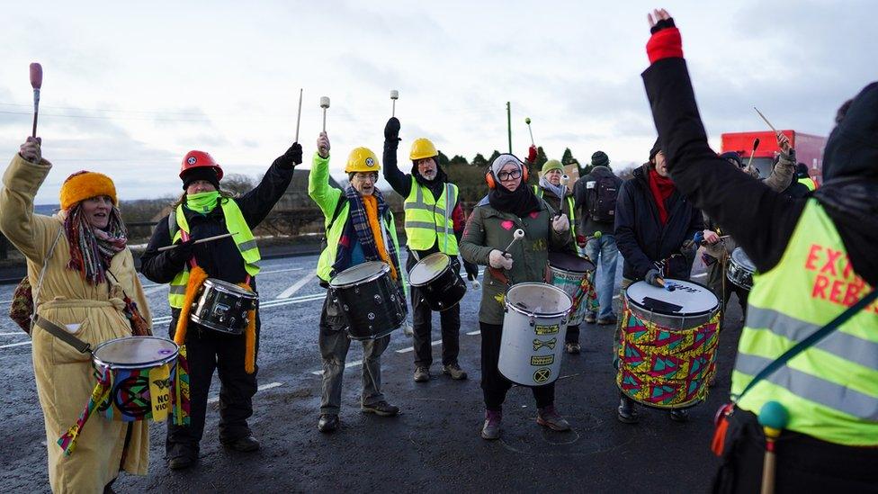 Protesters bang drums as the mine site