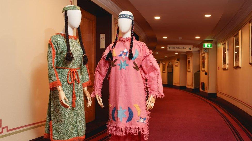 Two brightly coloured costumes on mannequins