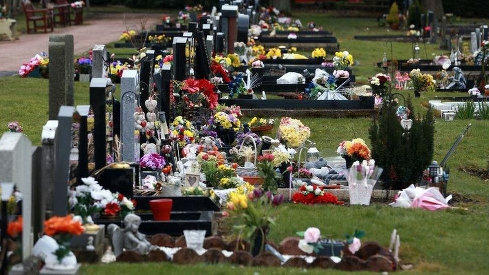 Floral tributes laid at gravestones at West Road Cemetery