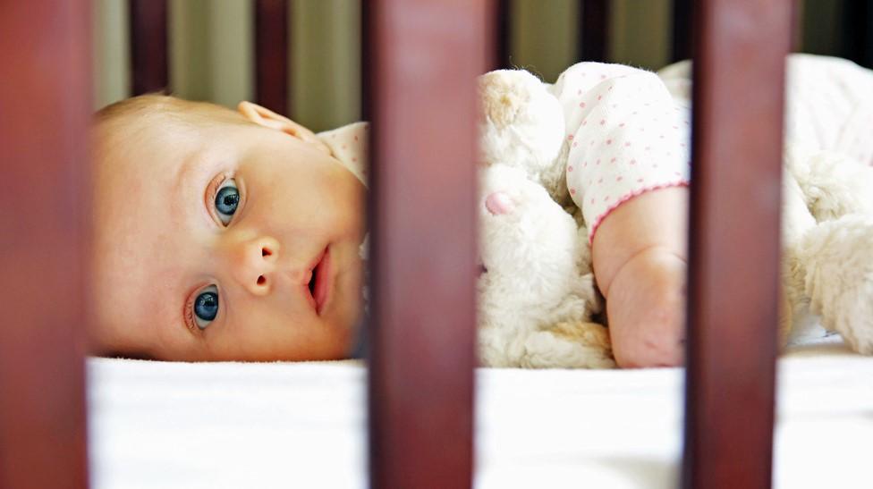 A baby in a cot