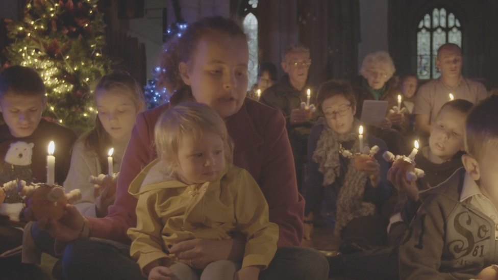 Children and parents at a Christingle service