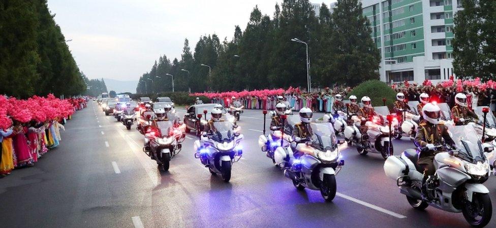 A convoy transporting South Korean President Moon Jae-in through the streets of Pyongyang, with cheering North Koreans lining the way