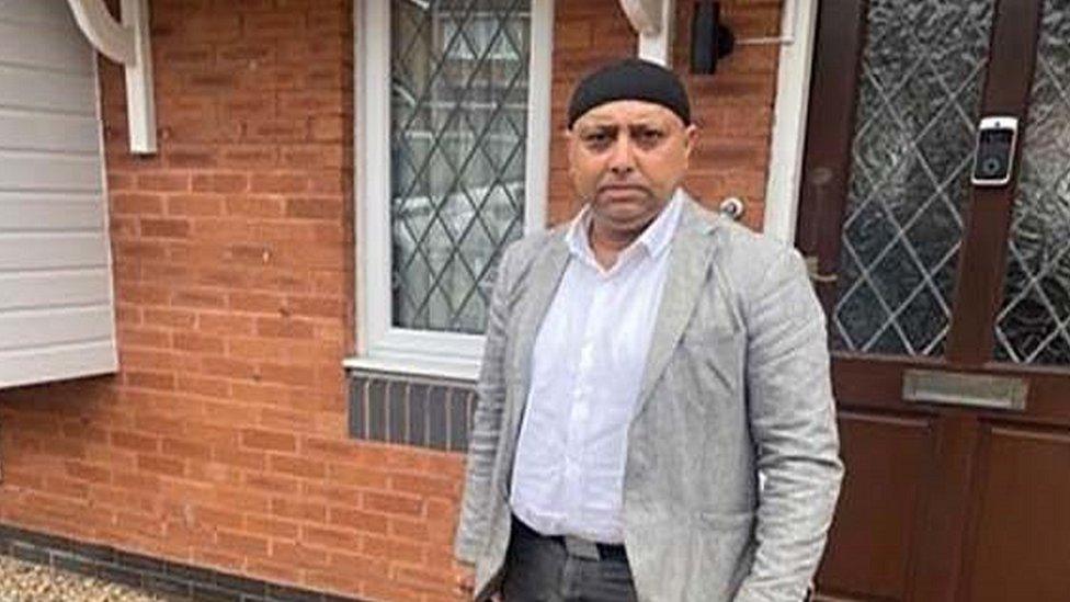 Faz Patel outside a house