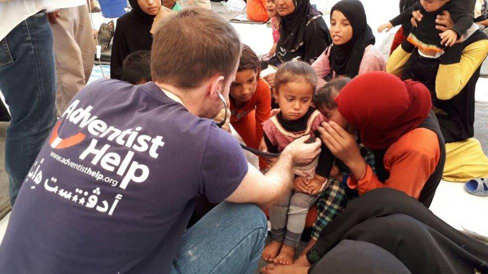 Workers at camp check children's health