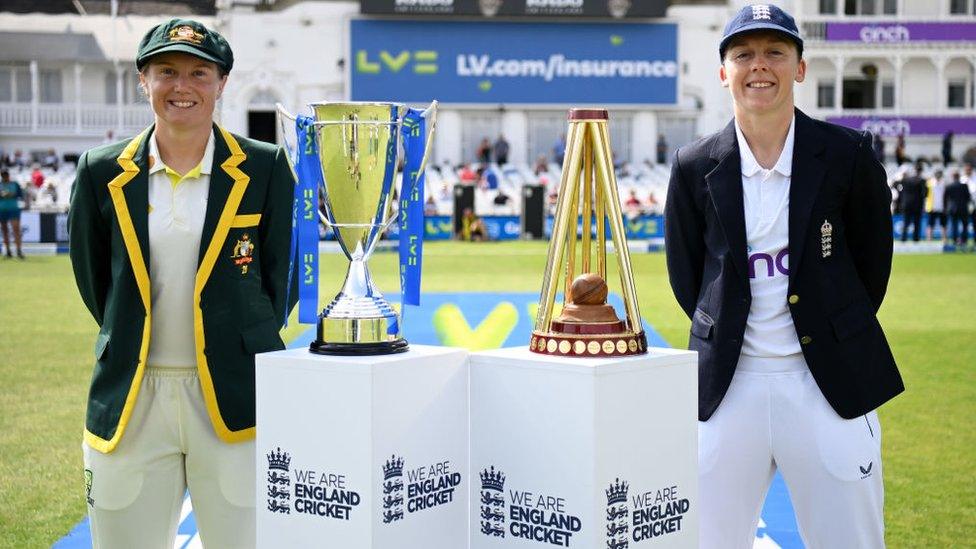Alyssa Healy of Australia and Heather Knight of England pose alongside the Ashes trophy