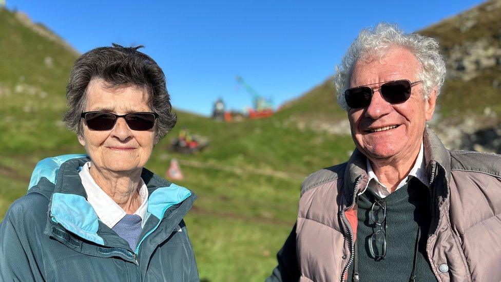 Couple in sunglasses in front of the gap