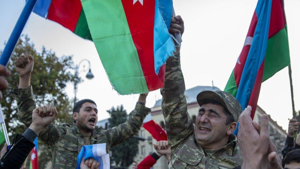 Azerbaijani people celebrate with a Veteran who lost his eyes and a leg in Terter region in 2002