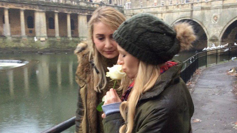 The girlfriends of Henry Burke and Christopher Taylor throw a white rose into the River Avon where the young men died
