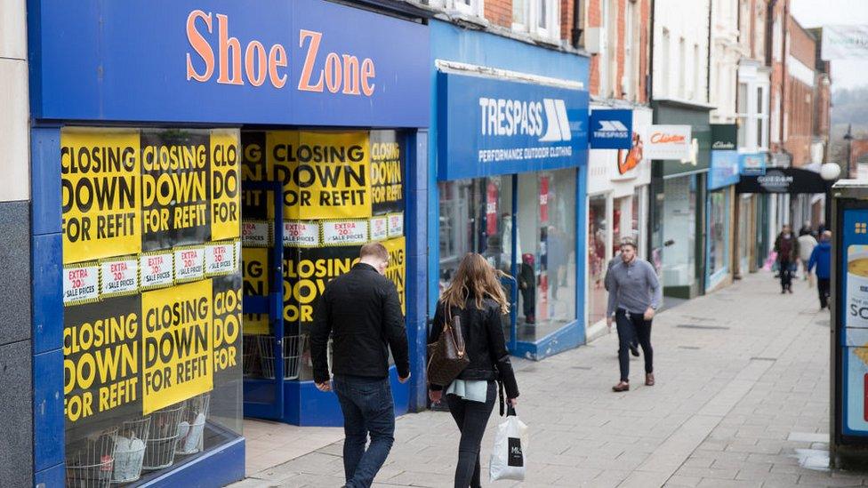 People walk past shops and retailers in the town centre of Yeovil