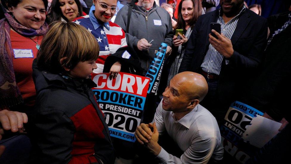 Cory Booker - kneeling in crowd