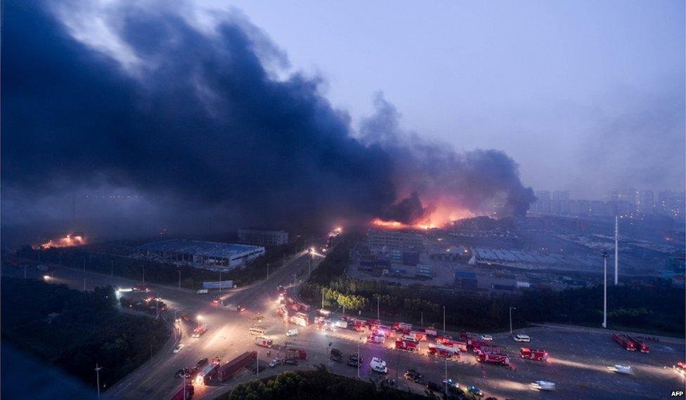 This file photo taken on 13 August 2015 shows fire and smoke rising after massive explosions hit the city of Tianjin.